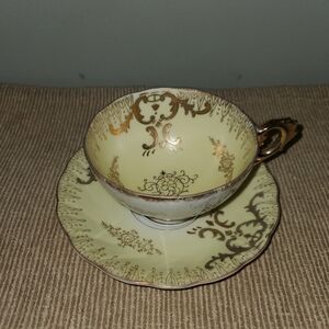 Elegant Gold and Cream Teacup and Saucer Set